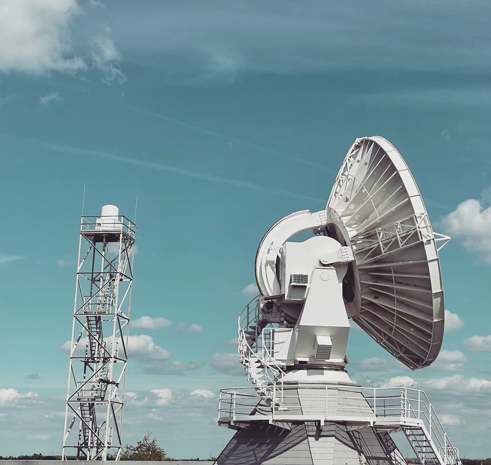 Large satellite dish antenna under a blue sky