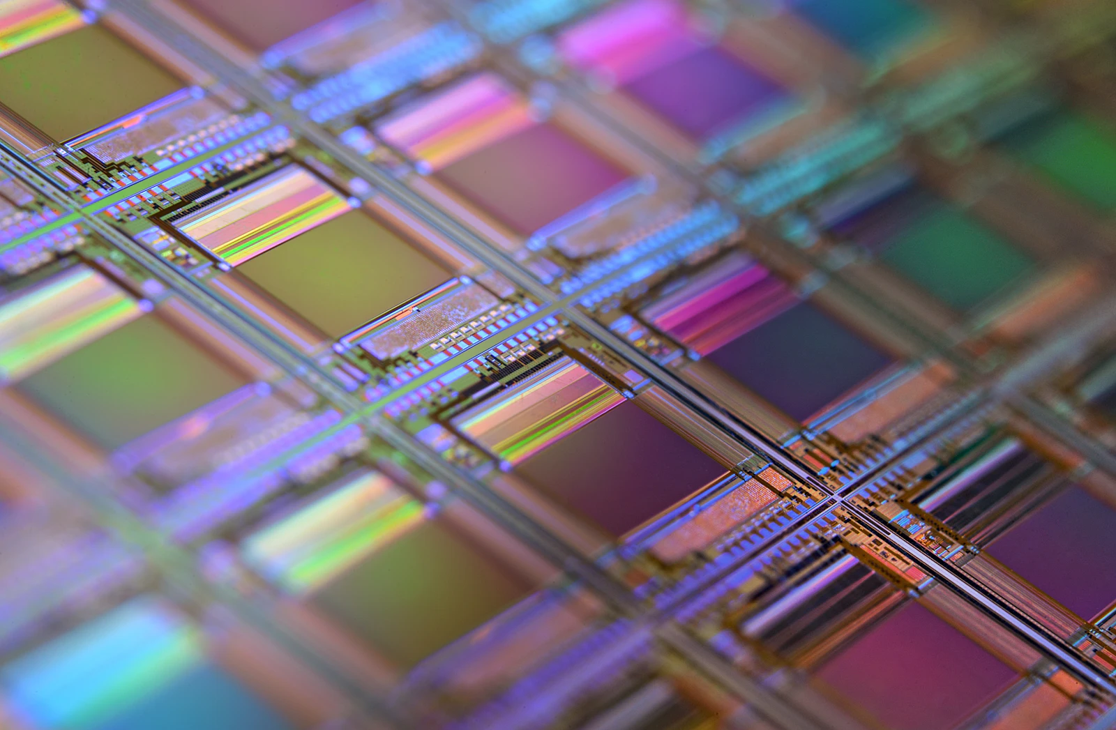 Close-up of a silicon wafer with iridescent microchip dies