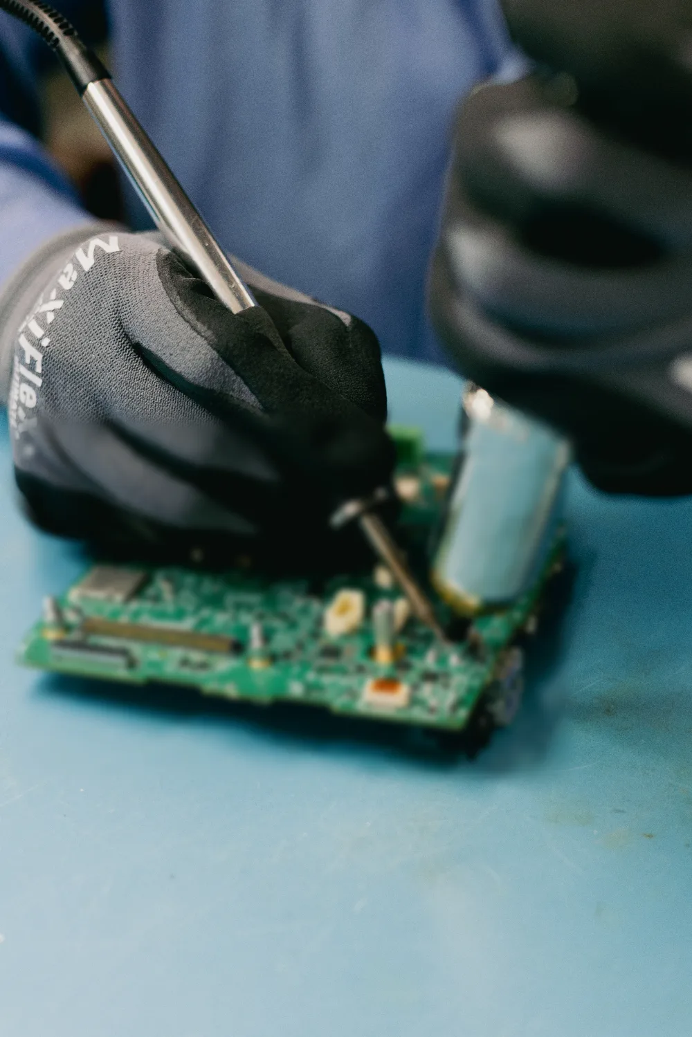 BSU technician hand soldering a board